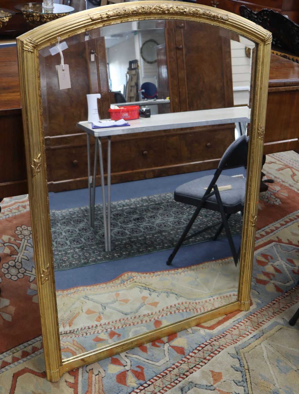 A gilt arched overmantel mirror, W.90cm, H.130cm